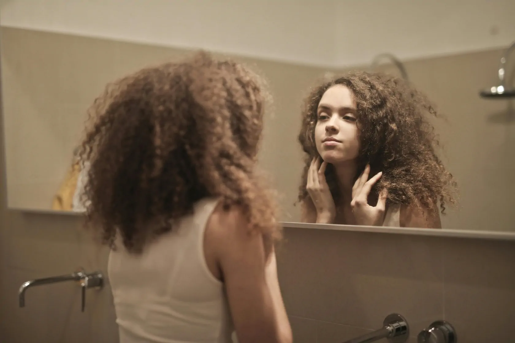 Woman Looking At Her Face In The Mirror 04